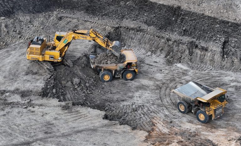 Work Of Trucks And The Excavator In An Open Pit